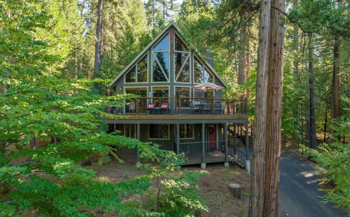 A-frame cabin tucked among tall redwood trees