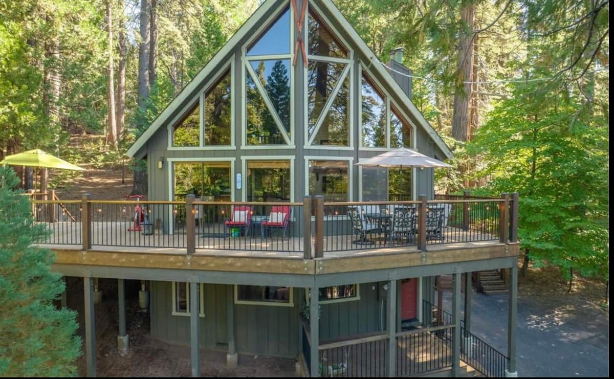 Front view of the A-frame cabin and spacious deck