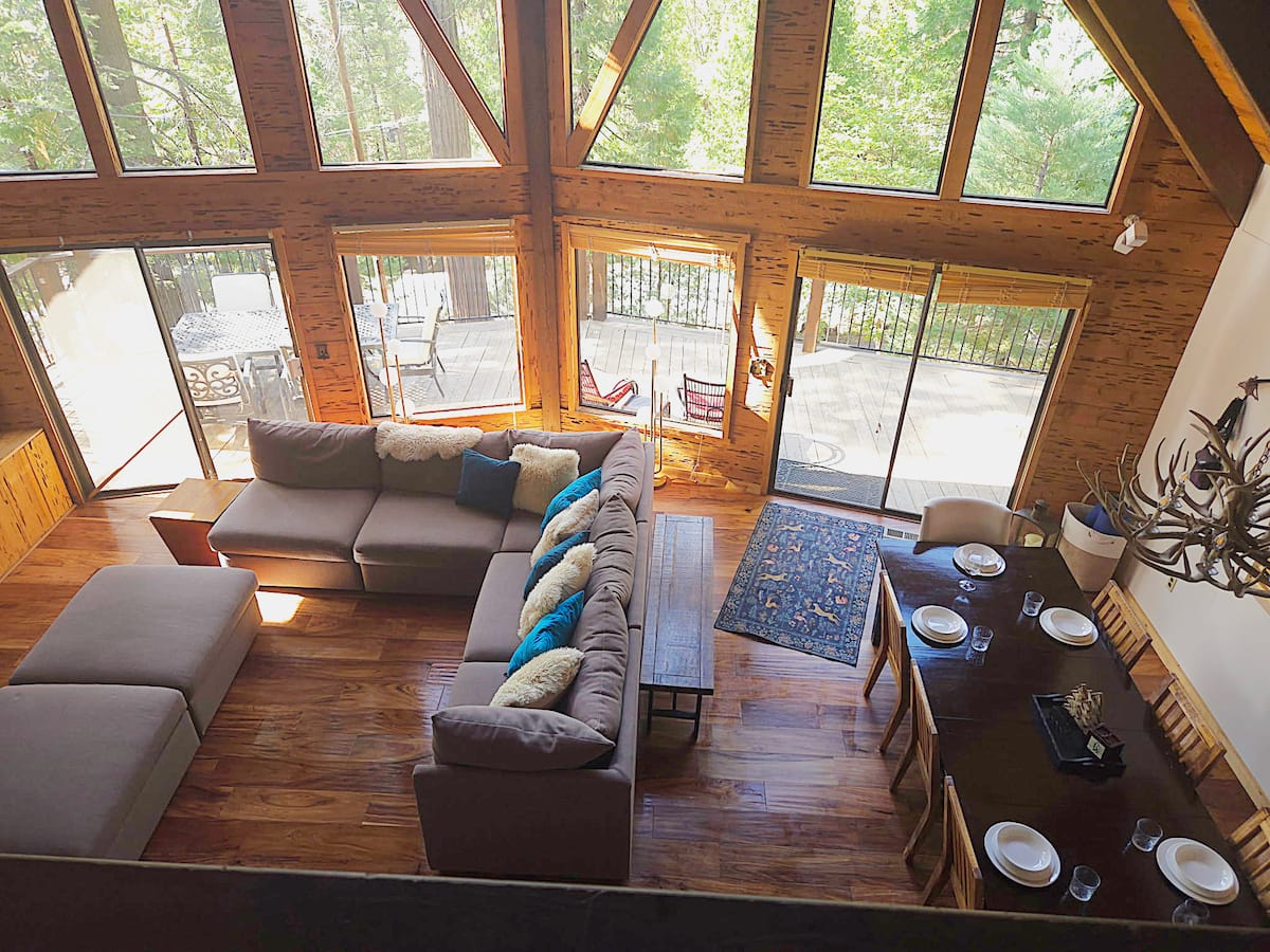 Great room, dining table, and deck viewed from the loft