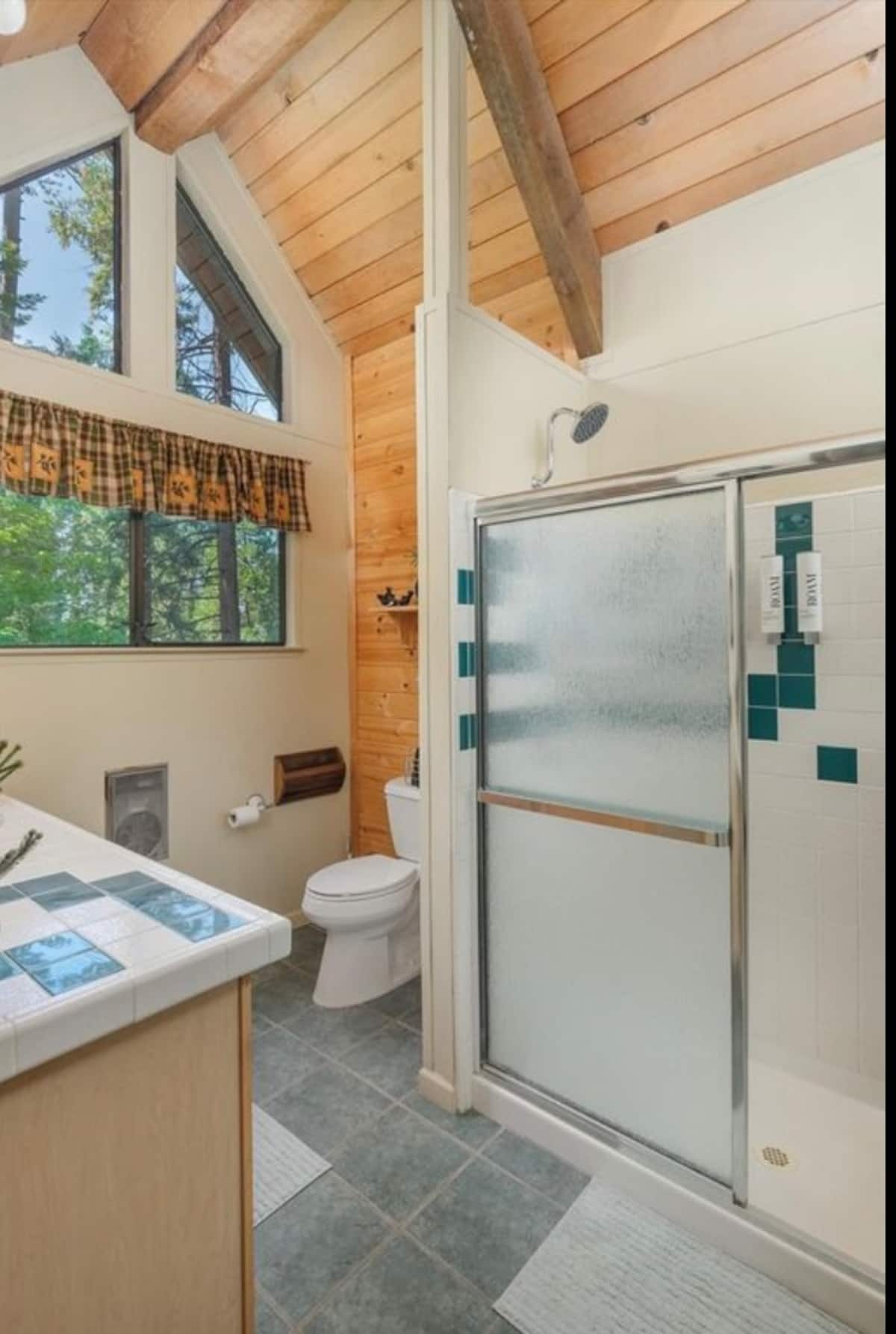 Bright full bathroom with glass shower