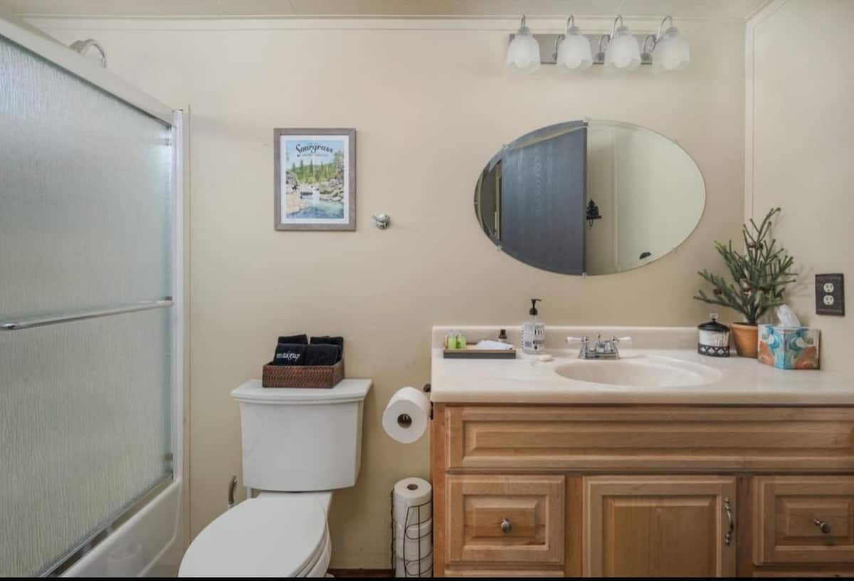 Guest bathroom with warm wood vanity