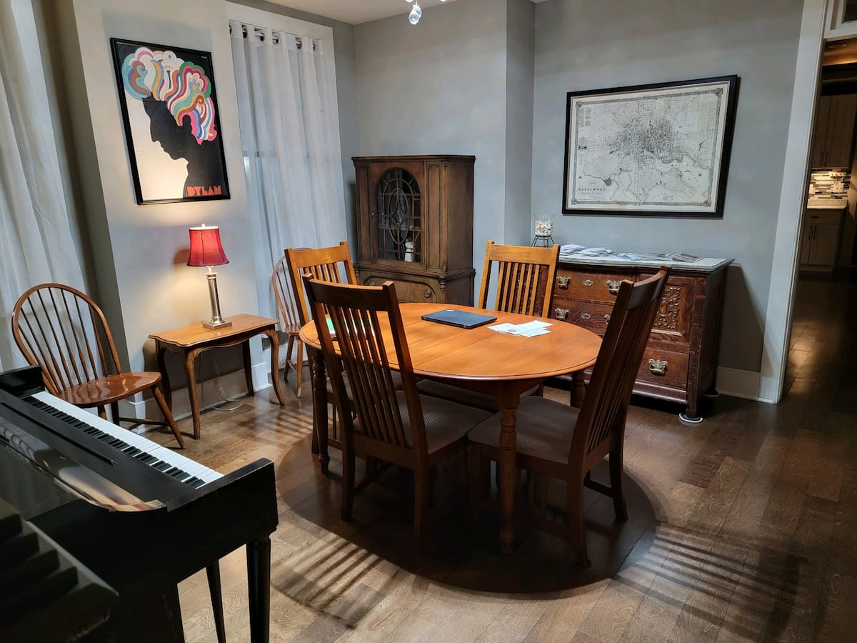 Dining room with a solid wood table and piano