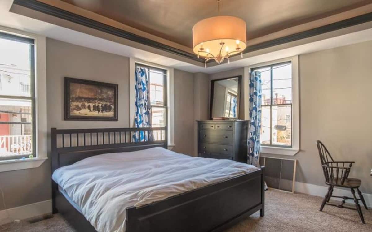 Second-floor primary bedroom with king bed and twin bed