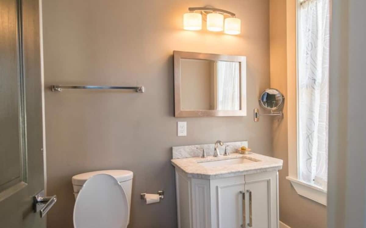 Bright guest bathroom with white vanity