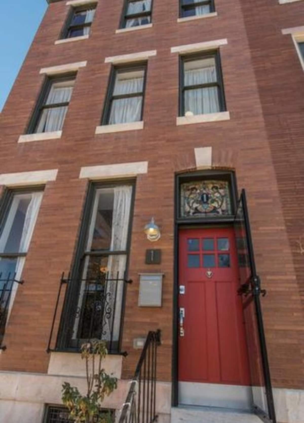 Historic brick row home with a red front door