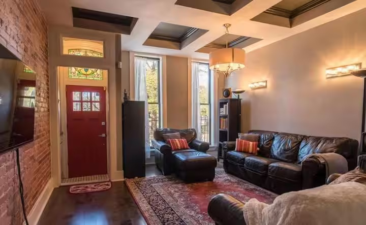 Caislean Crown living room with a bright red front door