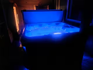 Private hot tub glowing blue at night