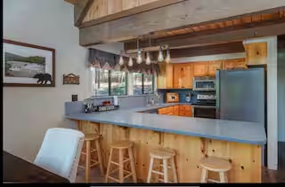 Open kitchen with a large island and forest views
